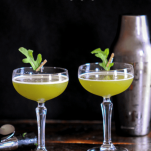 Green cocktails in coupes with leaves and silver shaker