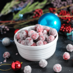 sugared cranberries in a bowl with ornaments