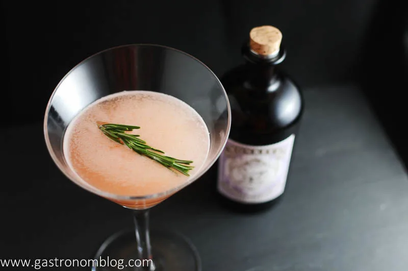 Top shot of gin and grapefruit cocktail with gin bottle