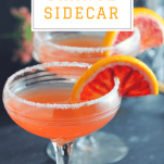 Blood Orange Sidecar Cocktail in sugar rimmed coupes with slices of blood orange
