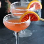 Orange cocktails in coupes with blood orange slices