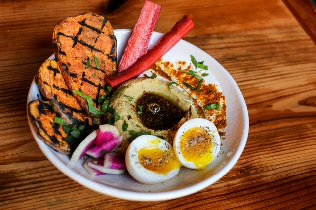 Hummus plate with hummus, eggs and vegetables for dipping at Kitchen Table Omaha