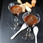 Chocolate dessert in glasses, white spoons