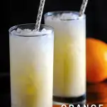 two orange cocktails in tall glasses with purple straws, orange in background