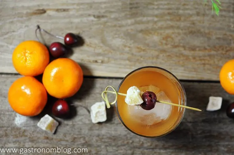 Ginger Clementine Old Fashioned Cocktail with candied ginger, cherries and clementines. Ginger Old Fashioned. 