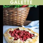 Galette on parchment paper. Basket with leaves in background.