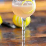 Pink cocktail in coupe with lemon peel