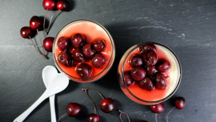 Old Fashioned Panna Cotta in glasses with brandied cherries and white spoons