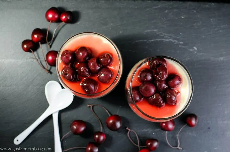 Old Fashioned Panna Cotta in glasses with brandied cherries and white spoons
