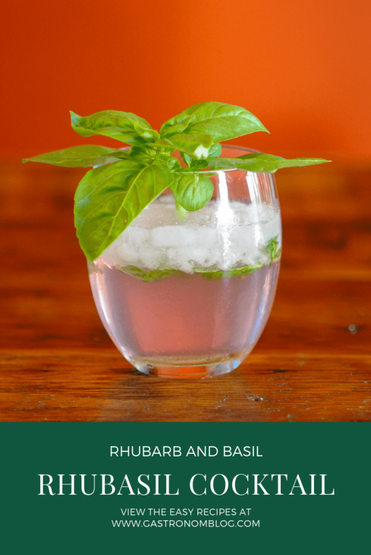 Rhubasil Cocktail in a glass with a bunch of basil