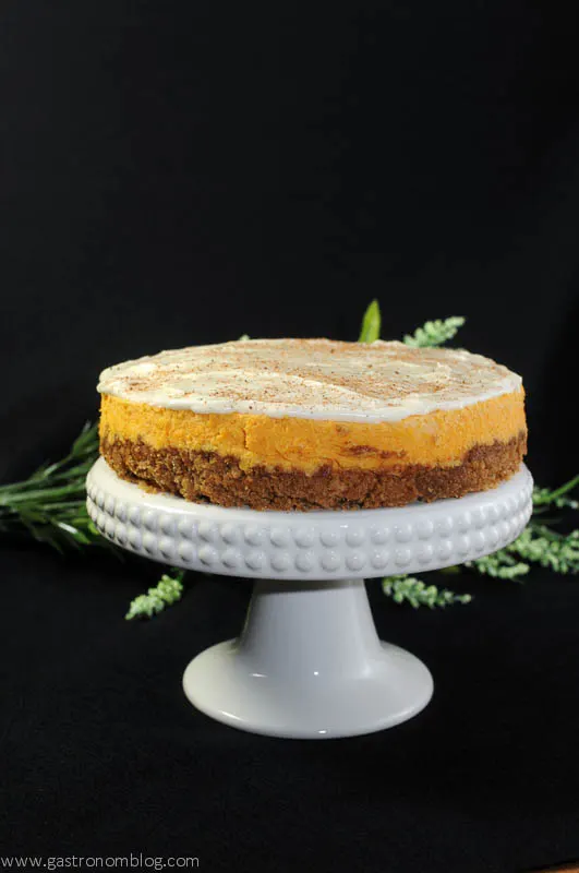 Carrot Cheesecake on a white pedestal plate