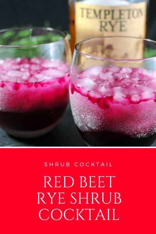 Beet Shrub Rye Cocktail - red cocktails in glasses with crushed ice. Whiskey bottle behind glasses. 