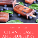 Wine Popsicles on a slate with blueberries and basil leaves