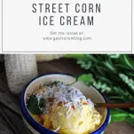 Mexican Street Corn Ice Cream - yellow ice cream topped with shredded cheese in colorful striped bowl. Ears of corn and greenery in background.