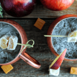 Mule cocktails in copper mugs with apples, caramels and ginger pieces