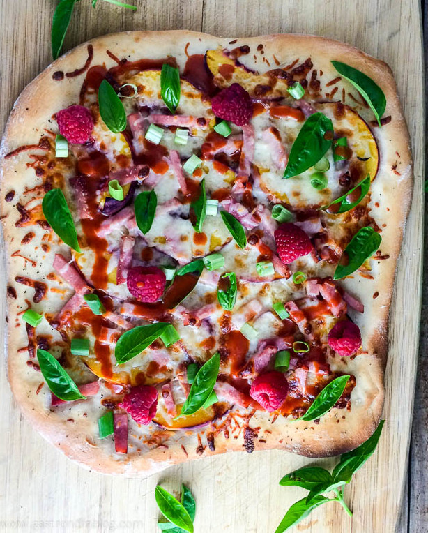 Peach and Raspberry Pizza on wooden cutting board