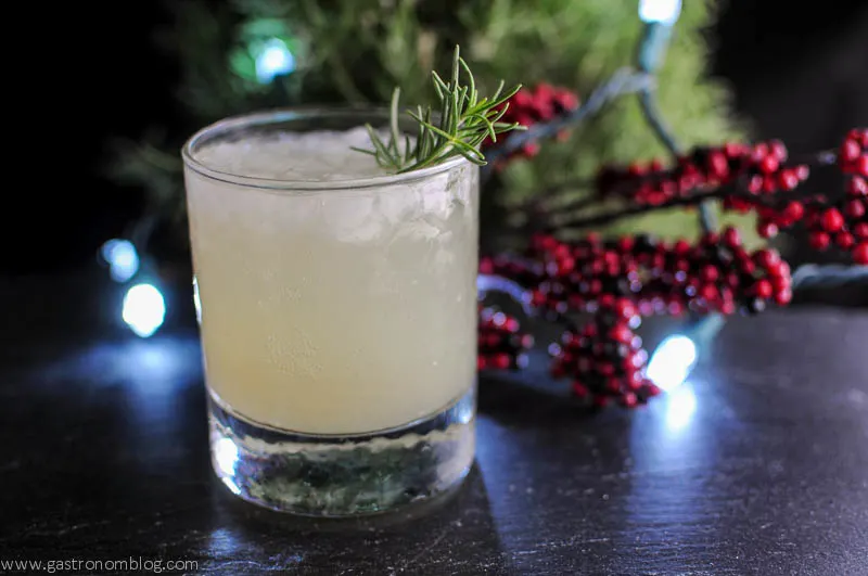 Rosemary's Pear cocktail in a rocks glass with tree in background