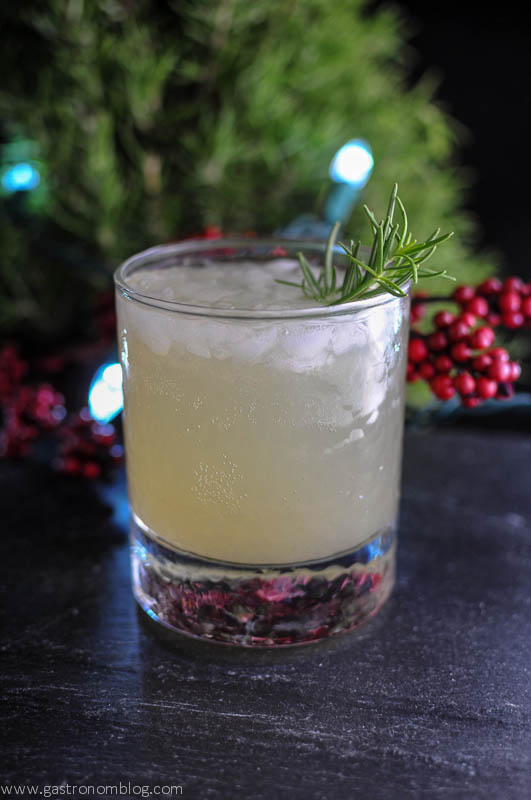 Rosemary's Pear - opaque cocktail with ice in rocks glass, greenery behind