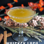 Gold colored cocktail with fall decor behind