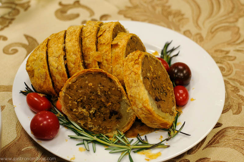 Vegan Whole Foods Thanksgiving dinner main course offering with tomatoes and rosemary on a white plate