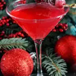 Red cocktail in martini glass with Christmas Decorations