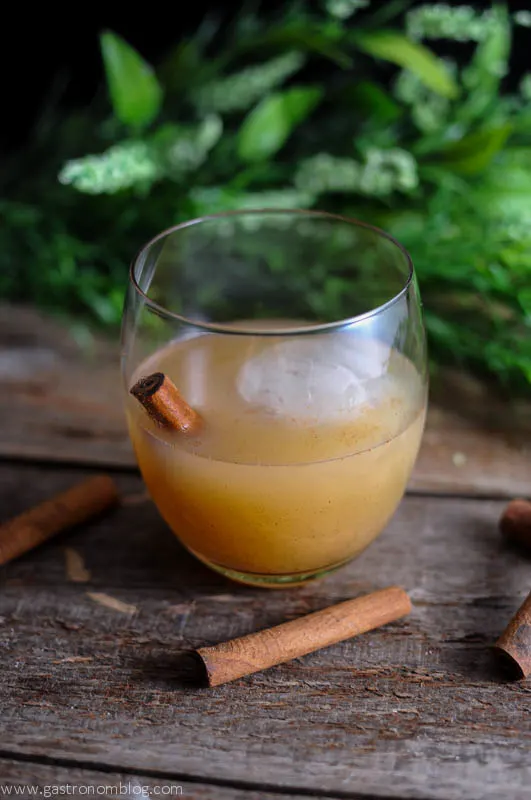 Spiced Pear Tequila Cocktail in a glass with cinnamon sticks
