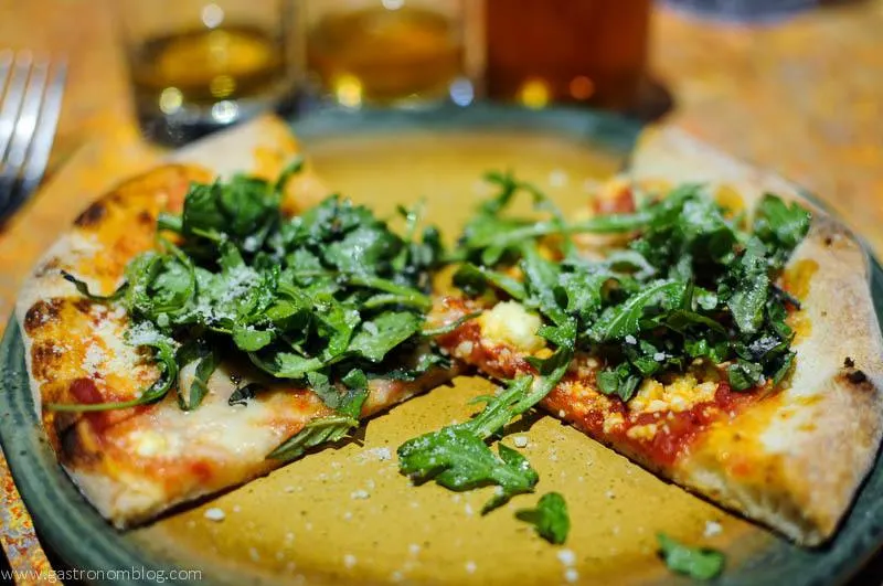 Pizza topped with arugula