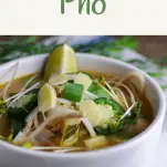 Crockpot Chicken Pho - in a white bowl, topped with jalapenos and lime slices