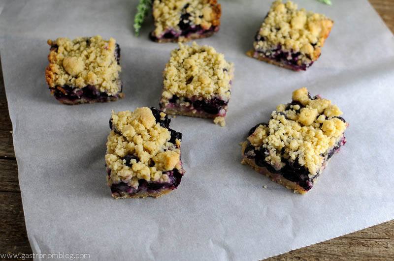 Blueberry Streusel Coffee Cake Bars on parchment paper