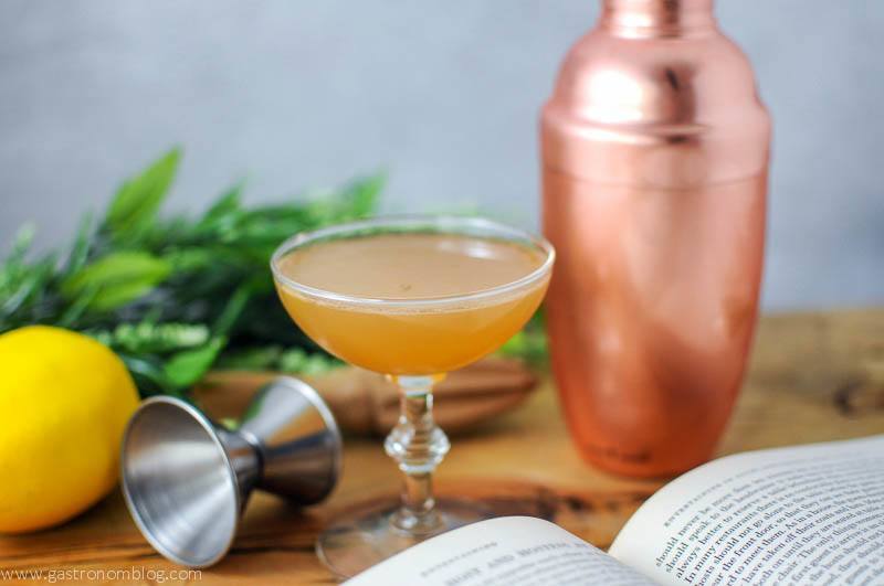 Ward Eight Cocktail, copper shaker, book and greenery in background