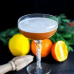 orange cocktail with white foam