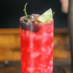 Bright pink cherry cocktail with lime and cherries