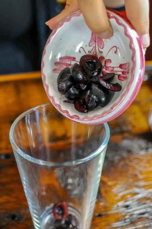 Cherries being poured into a glass