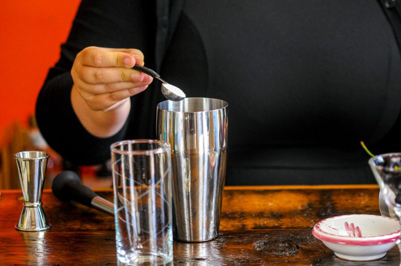 Sugar being poured into a shaker. 