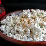 Popcorn with paprika and chives in wool bowl