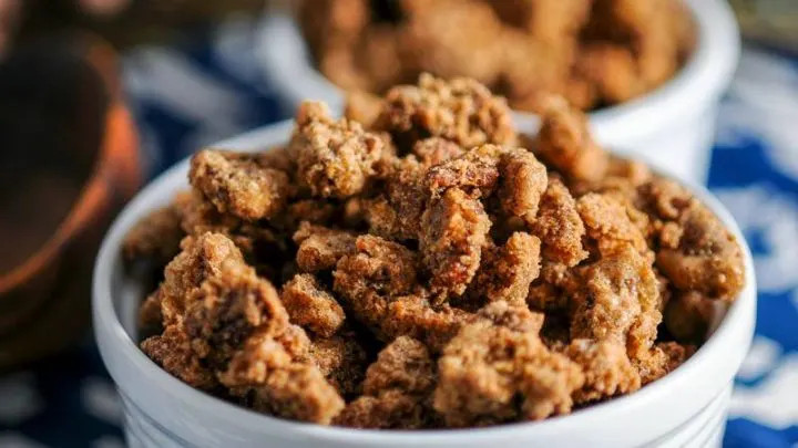 Bourbon Candied Pecans in wite bowls on blue and white napkin