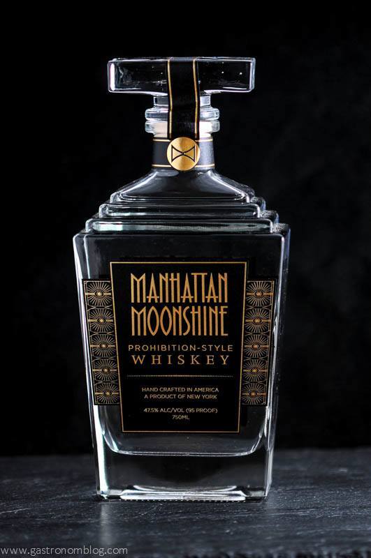 Manhattan Moonshine bottle on black background. Art Deco in design