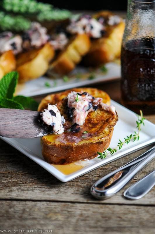 Blueberry and Thyme Butter on French Toast, wooden spoon with butter, jar of syrup behind