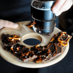 Chocolate Bark with prezels on wood tray, beer in a glass