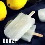 Boozy Popsicles - white popsicles stacked, lemons behind
