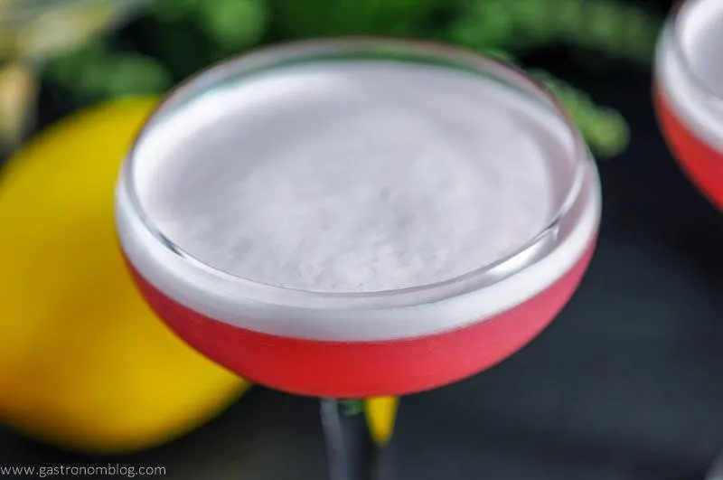 The Clover Club Cocktail - A pink gin and raspberry cocktail in a cocktail coupe with white foam
