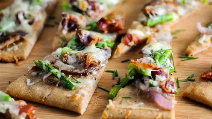 Bacon and Blue Cheese Flat Bread triangles on a wooden board