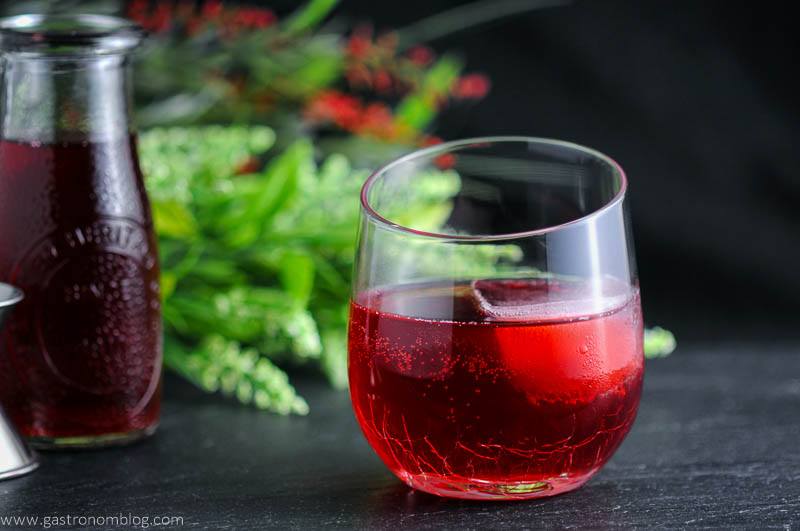 The Cranberry Sweet and Sour cocktail with a jar of simple syrup