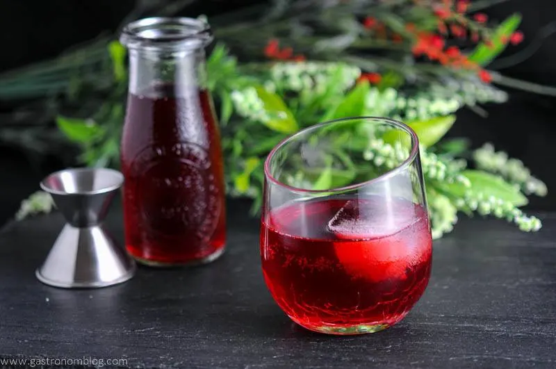 The Cranberry Sweet and Sour cocktail with a jar of simple syrup 