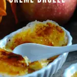 Creme Brulee in white ramekins, apples and leaves behind