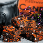 brownies with orange layer and googly eyes with Halloween themed backdrop