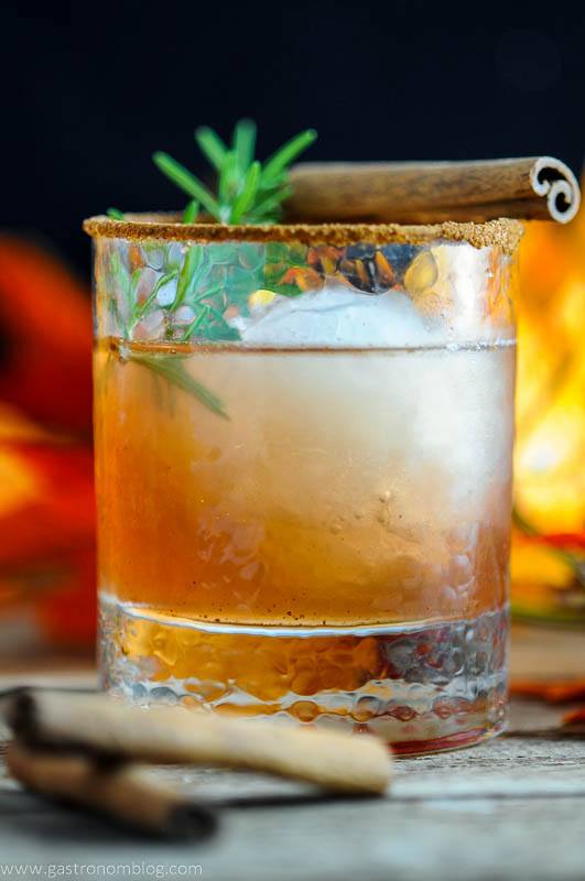 The Autumn Pear cocktail - brown cocktail in rocks glass with ice, cinnamon stick and rosemary