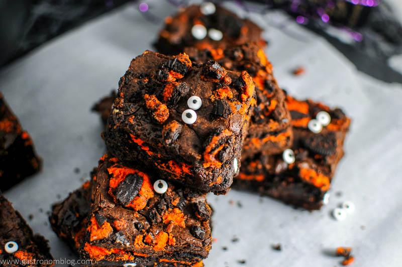 Halloween Oreo Monster Brownies - stacked up on parchment paper with googly eyes