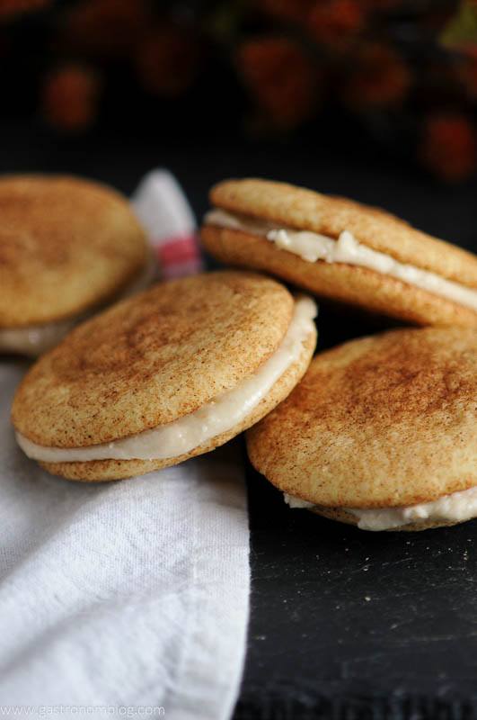 Pumpkin Spice Snickerdoodle Whoopie Pies in a pile on white napkin