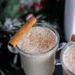 Eggnog in mugs with cinnamon Stick